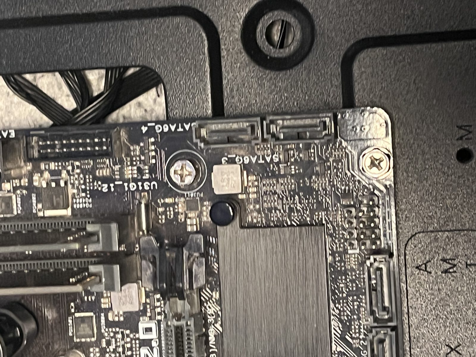 Motherboard lowered into the case against the I/O shield