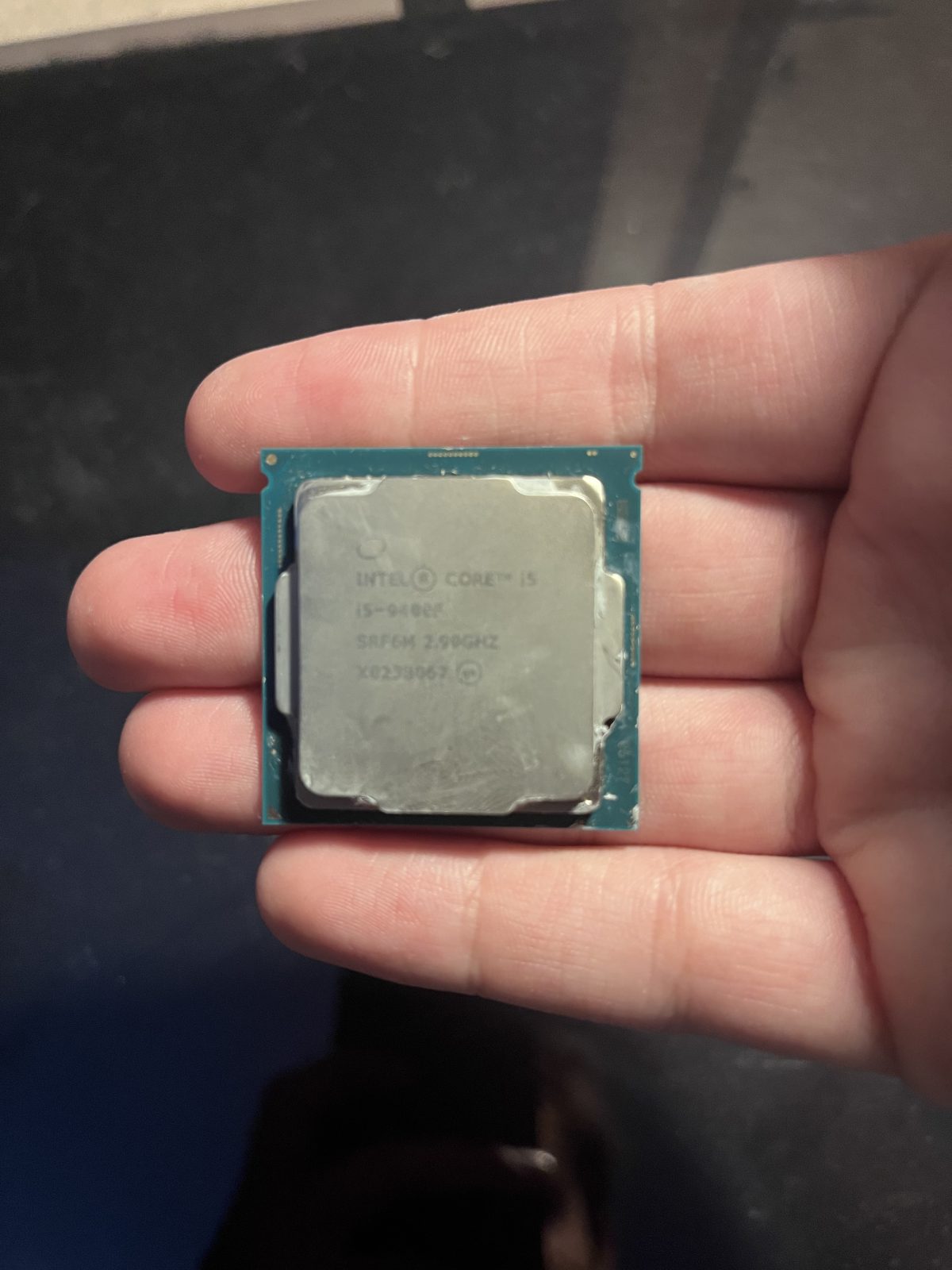 Intel Core i5-9400F processor held in hand