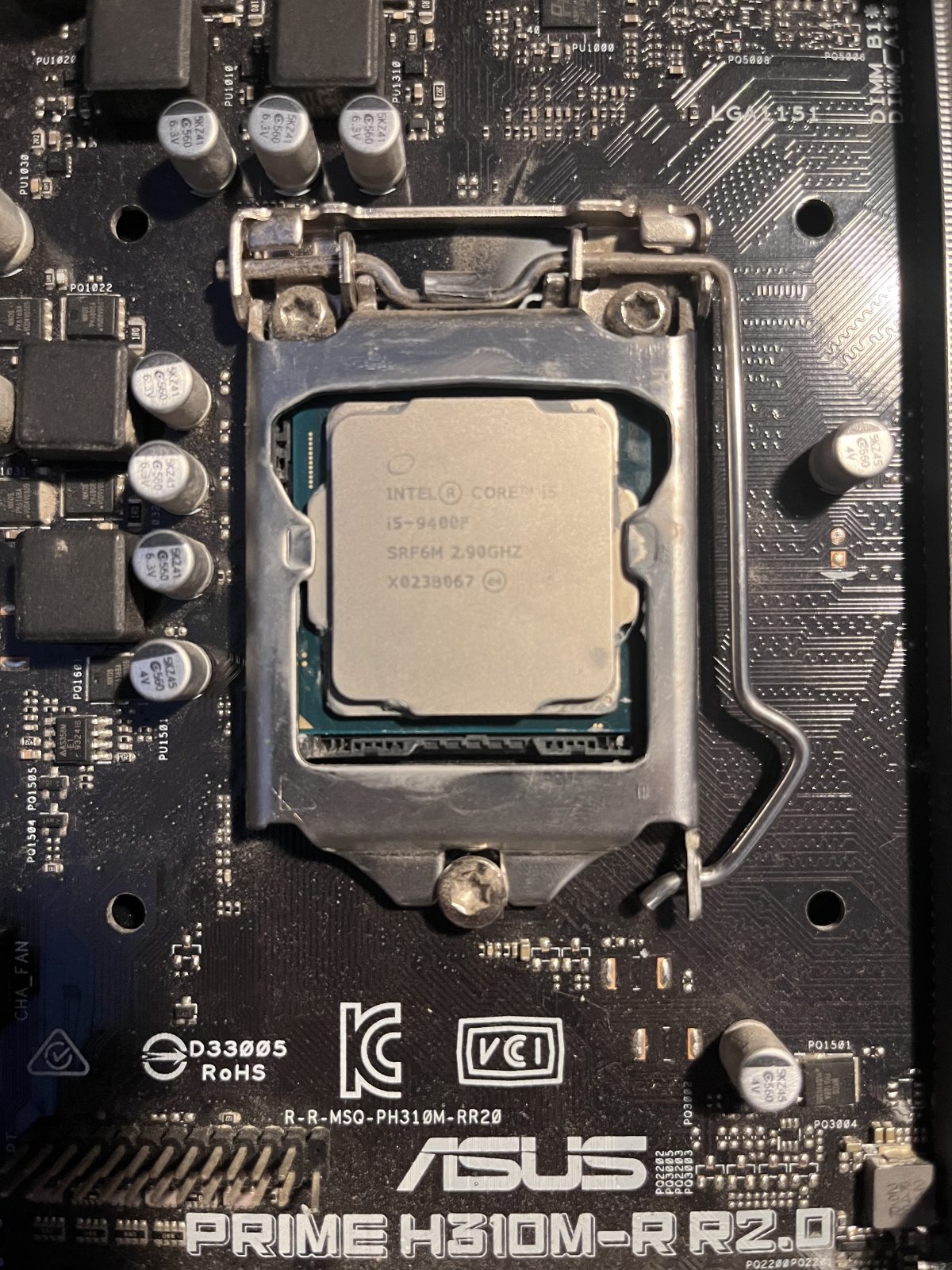 Intel i5 CPU seated in the motherboard socket with the retention arm closed
