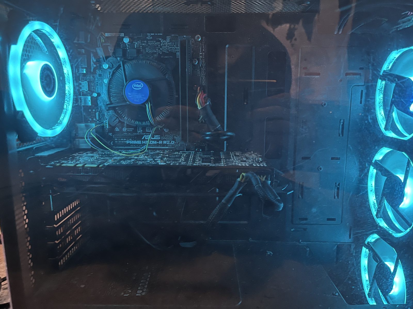 The finished PC build powered on with blue LED case fans