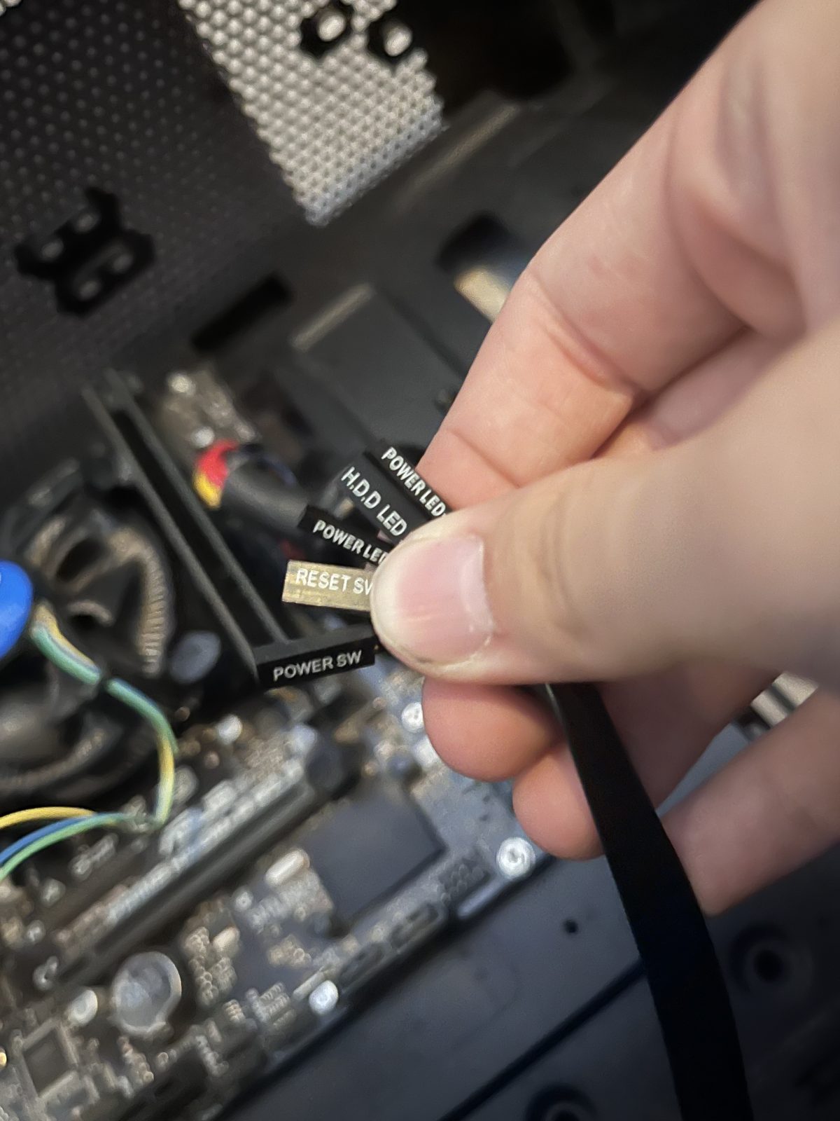 Front-panel connector leads being plugged into the motherboard header